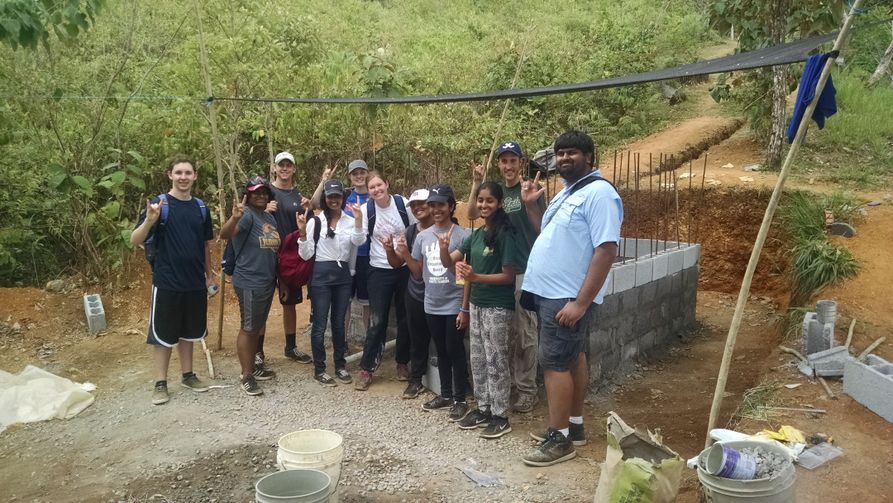A group of University of South Florida students helping construct a drinking water storage tank